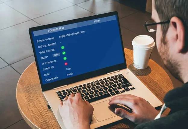 man-working-on-notebook-apilayer-email-validator-api-via-pexels.jpg.webp